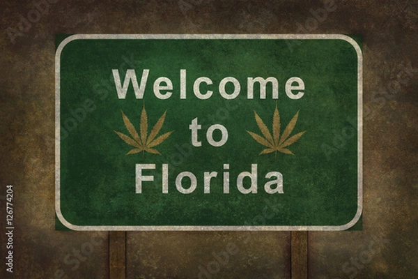 Fototapeta Welcome to Florida with marijuana leaf, roadside sign with ominous background