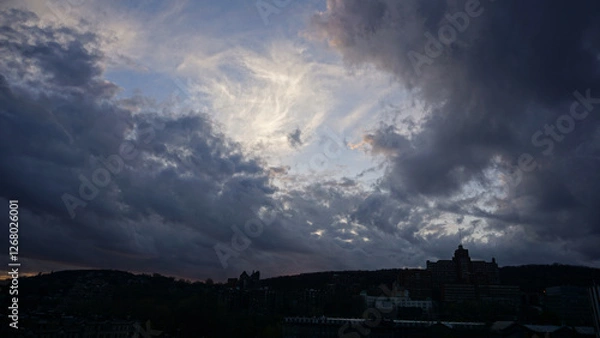 Obraz The red and blue dancing clouds with setting sun