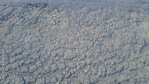 Fototapeta cracks in asphalt roads as background. cracks in asphalt roads due to frequent heavy vehicles and poor road construction	
