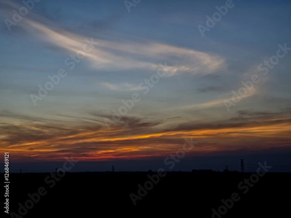 Obraz Sunset sky with dark clouds in the background