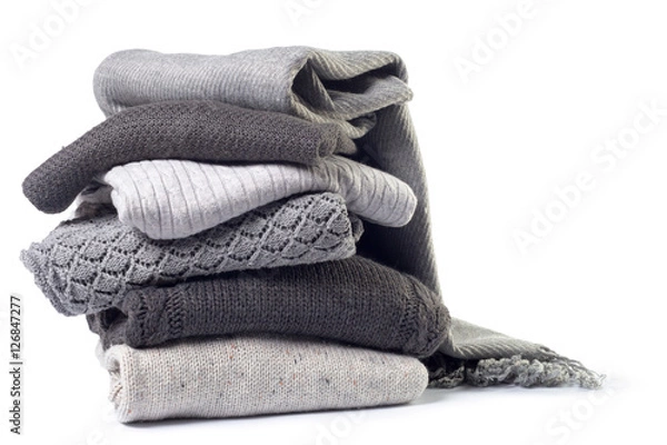 Fototapeta Stack of various sweaters isolated on white background