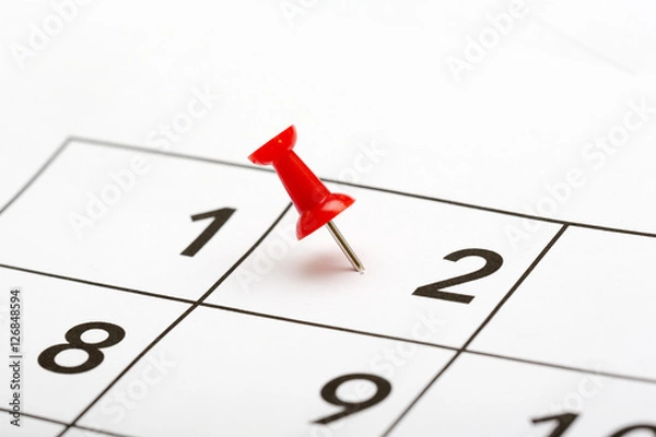 Fototapeta Pin on the date. The second day of the month is marked with a red thumbtack. Focus point on the red pin.