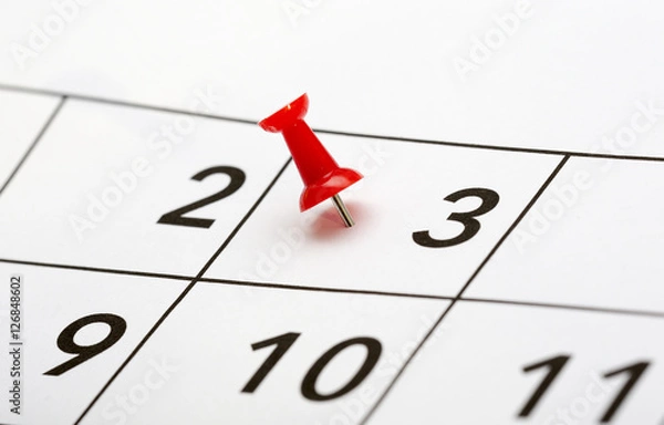 Fototapeta Pin on the date. The third day of the month is marked with a red thumbtack. Focus point on the red pin.