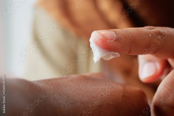 Fototapeta Caring for skin with moisturizing cream during a self-care routine