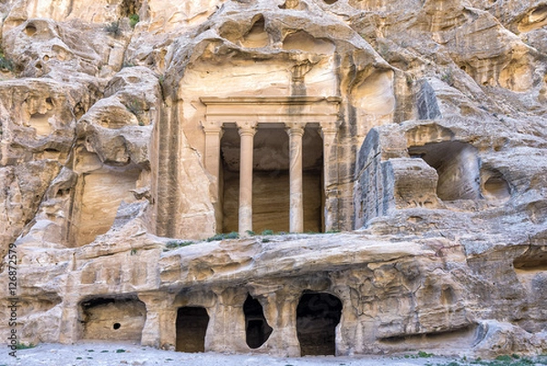 Fototapeta The triclinium at Little Petra, Jordan. Little Petra is an archaeological site located north of Petra. Like Petra, it is a Nabataean site, with buildings carved into the walls of the sandstone canyons