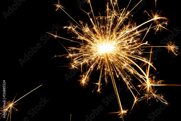 Obraz Burning sparkler at black background