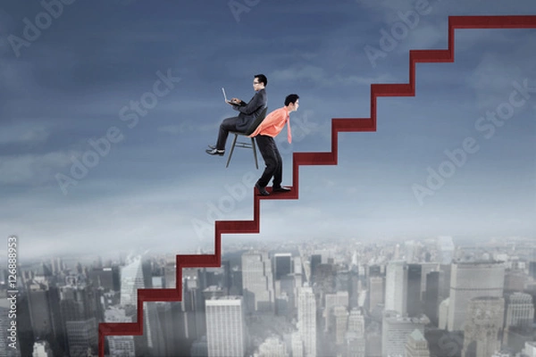 Fototapeta Businessman and his colleague with red stair