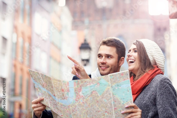 Obraz Pretty couple sightseeing with map