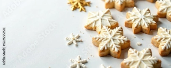 Fototapeta Snowflake-patterned cookies on a white background with golden accents, gold, snowflakes, baking