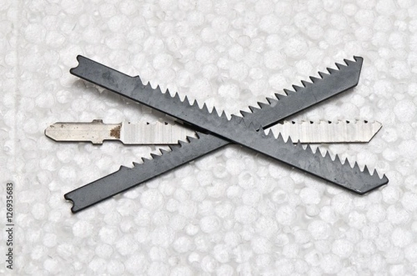 Obraz Three blades  /  Three used reciprocating saw blades on the desk.