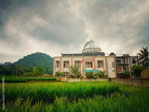 Fototapeta Sunday, February 16, 2025 Karawang Indonesia Arrahmah Mosque in the middle of the rice fields