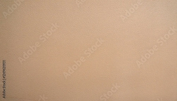 Fototapeta close up view of a light beige wall with a subtle fine grained texture creating a warm and inviting brown backdrop with a slightly rough almost sandy feel