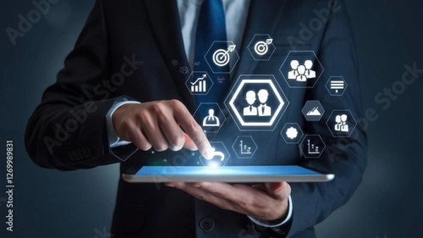 Fototapeta Businessman interacts with digital interface on his tablet device