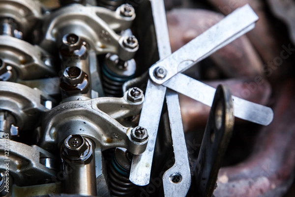 Fototapeta Technician service tuning engine's valve