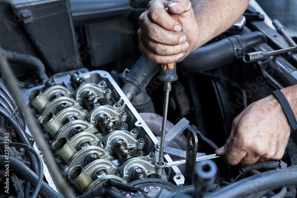Fototapeta Technician service tuning engine's valve