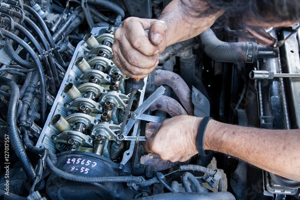 Fototapeta Technician service tuning engine's valve