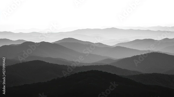 Fototapeta Serene monochrome mountain landscape showcasing layered hills fading into the horizon