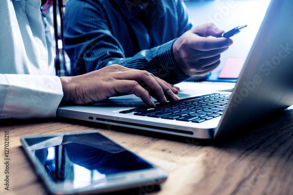 Fototapeta Businessman and partner checking reported profits on laptop. col