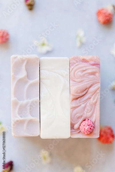 Fototapeta Three artisan soaps with elegant swirls and a decorative raspberry