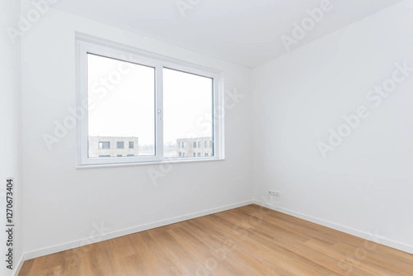 Fototapeta interior empty basic bedroom in modern new build residential smart house. Glass window is neighboring building over the road. Plain white walls and wood effect vinyl flooring make blank canvas