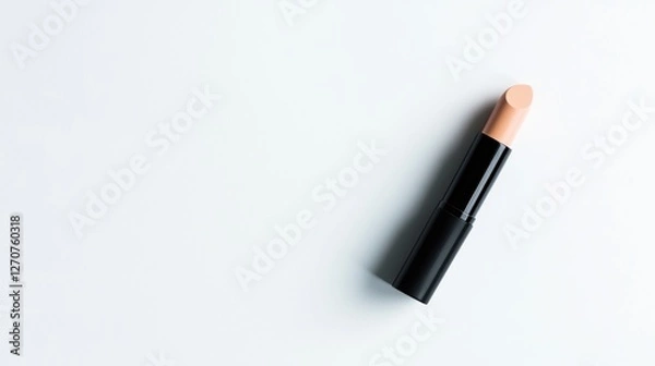 Obraz Black concealer stick with a neutral shade on white surface