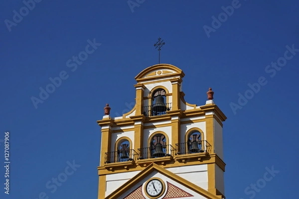 Fototapeta Top of the church in the town of La Linea de la Concepcion in southern Spain as a typical Spanish bell tower, symbol of Spanish religious architecture and design 