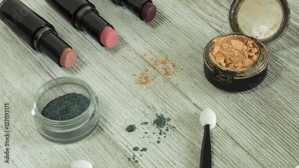 Obraz lipstick and eyeshadow scattered