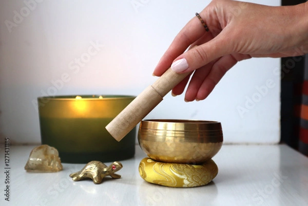 Fototapeta Spiritual Harmony: Meditation & Healing Rituals. Playing Tibetan bowl. Singing bowl and burning candles. Sound vibration healing.