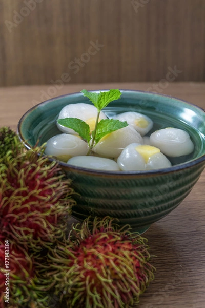 Obraz Peeled rambutan stuffed with pineapple in syrup.