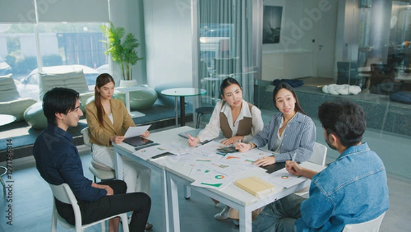 Fototapeta Confident Women leader discussing strategy meeting teamwork collaboration business growth analysis financial data presenting reports managing startup success corporate office people partnership