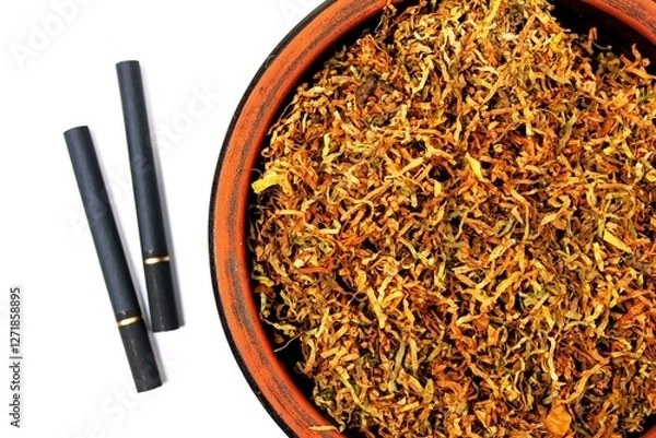 Fototapeta Fermented yellow tobacco in a brown plate on a white background and two cigarettes