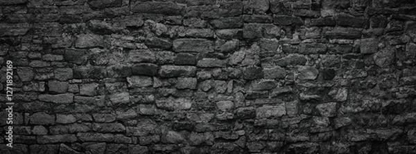 Obraz black stone wall an old castle, dark background of slate bricks