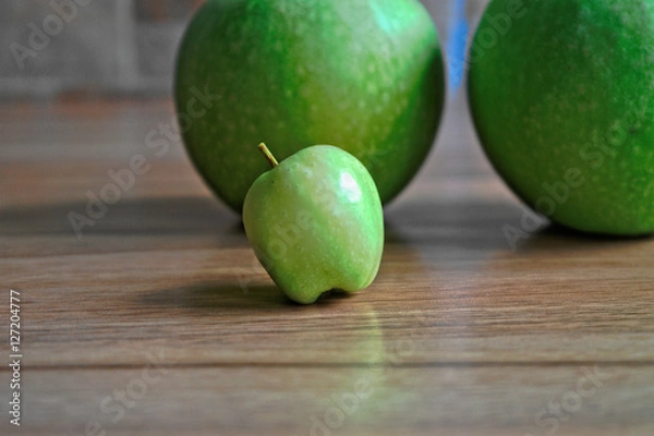 Obraz Tiny green apple on a wooden table