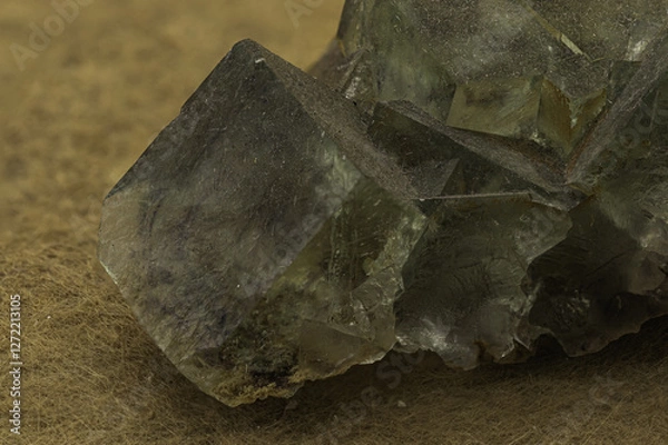 Fototapeta An impressive cluster of fluorite crystals exhibiting a translucent green hue and distinct cubic formations, set against a tan background