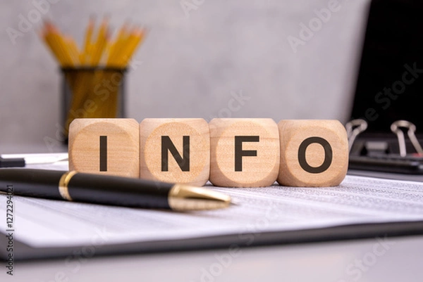 Obraz wooden cubes spelling INFO on an office desk, symbolizing content creation, writing, and marketing