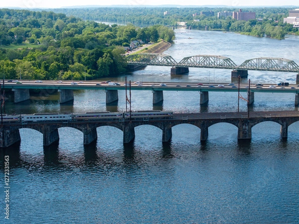 Obraz train on the move over a river