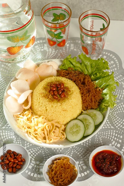 Obraz a complete plate of yellow rice which is Indonesian food