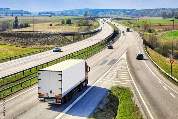 Obraz Motorway traffic with a heavy truck pulling semi trailer, rear view. 