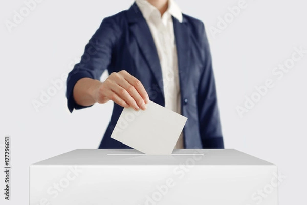 Obraz Voting. Wonam putting a ballot into a voting box.