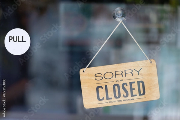 Obraz A sign hanging from a window that says Sorry I am closed