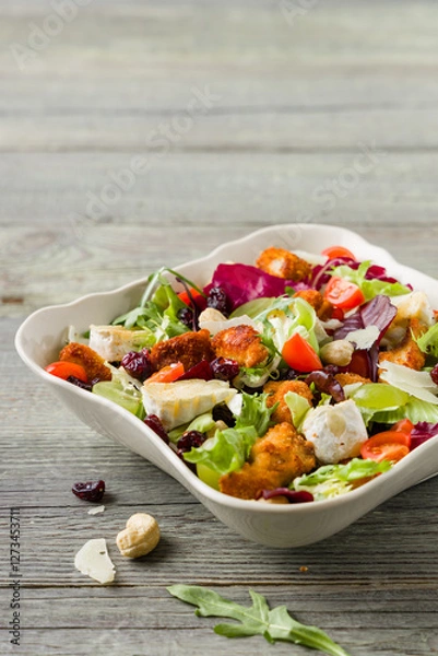 Obraz Traditional spring Italian salad with breaded chicken, camembert cheese, grapes and nuts. Served with croutons.