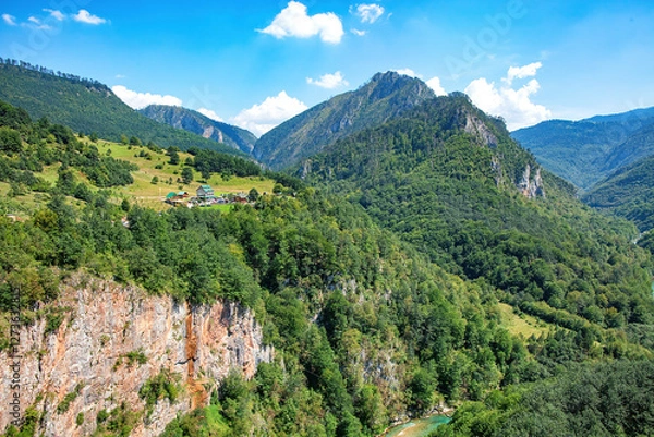 Obraz Majestic mountain landscape with lush greenery and serene river in a quiet valley