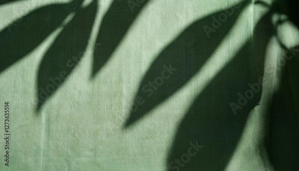 Fototapeta abstract botanical pattern sunlight shadow silhouette of leaves on linen sage green fabric aesthetic background for sustainable eco business brand