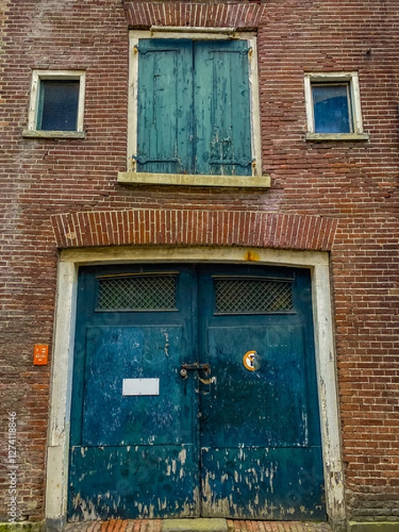 Fototapeta old green window with red shutters