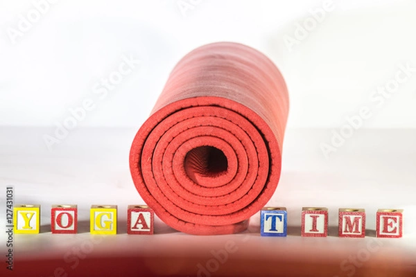 Obraz Rolled up yoga mat with words yoga time spelled with wooden alphabet letter blocks 
