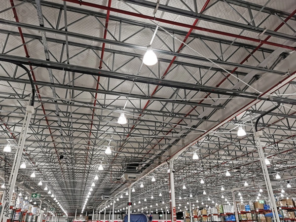 Obraz Large warehouse illuminated with numerous lights and a multitude of spotlights on the ceiling