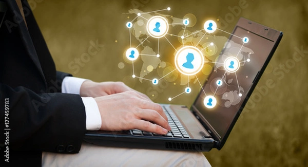 Fototapeta Close up of hand with laptop and social media icons