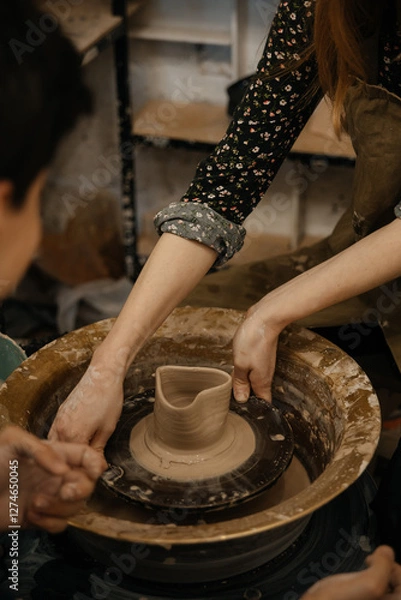 Fototapeta hands of a potter, making heart from glay