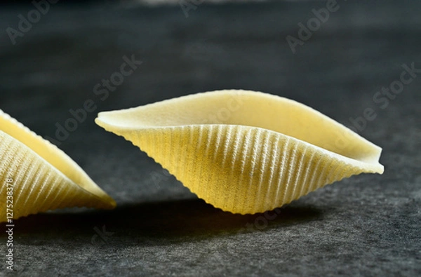 Fototapeta Ready to get Conchiglie. Close-up of a giant conchiglie pasta shell. Italian cuisine.