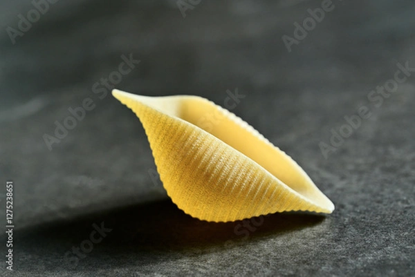 Fototapeta Ready to get Conchiglie. Close-up of a giant conchiglie pasta shell. Italian cuisine.